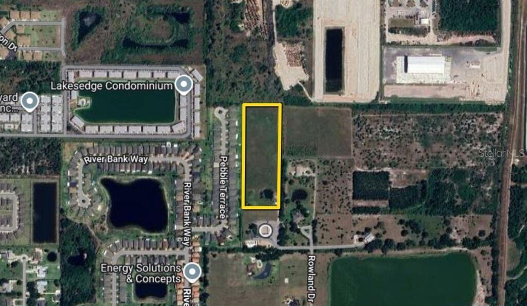 An aerial map shows a rectangular plot of land highlighted in yellow near residential developments — 3400 ROWLAND DRIVE UNIT Tract A, PUNTA GORDA, FL