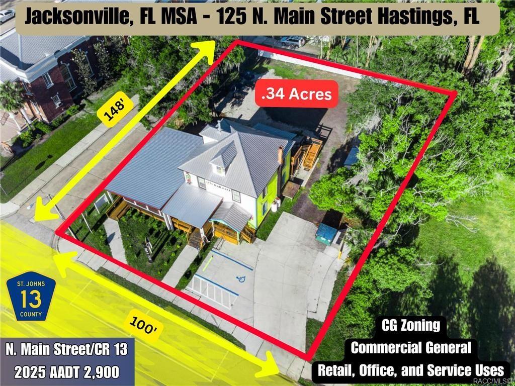 An aerial view shows a commercial building on a .34-acre lot with parking — 125 N MAIN STREET, HASTINGS, FL