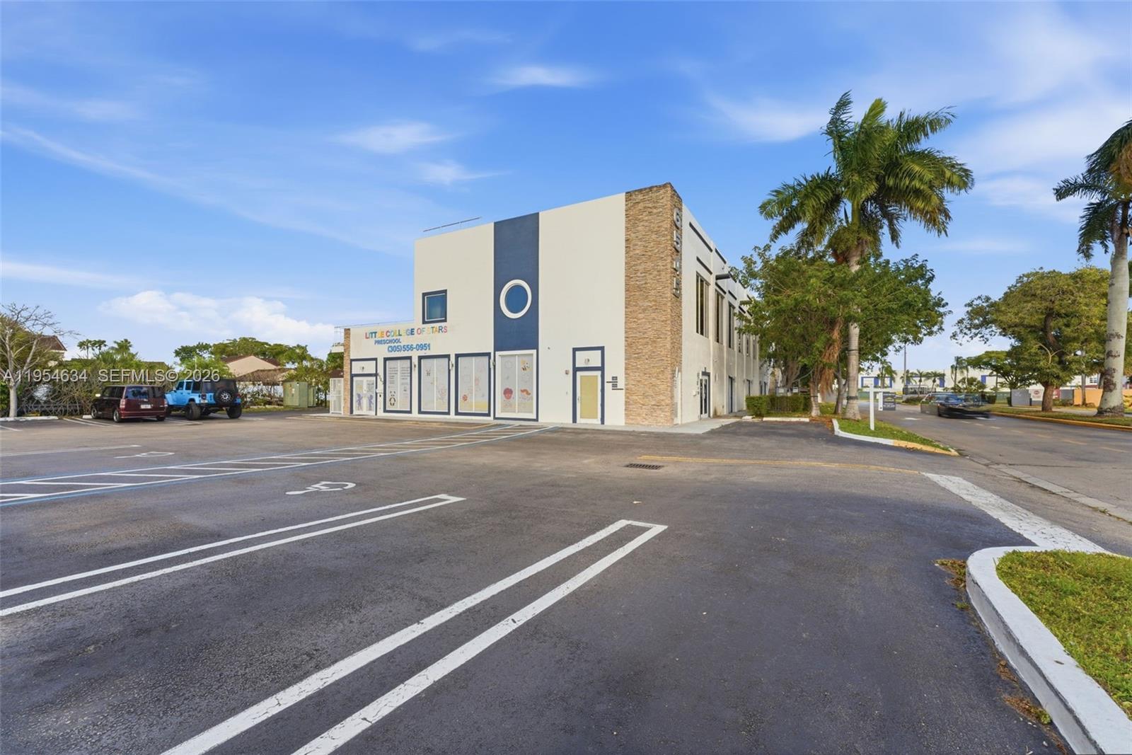A two-story commercial building with a parking lot and palm trees under a blue sky — 6545 NW 169th St, Hialeah FL 33015, HIALEAH, FL