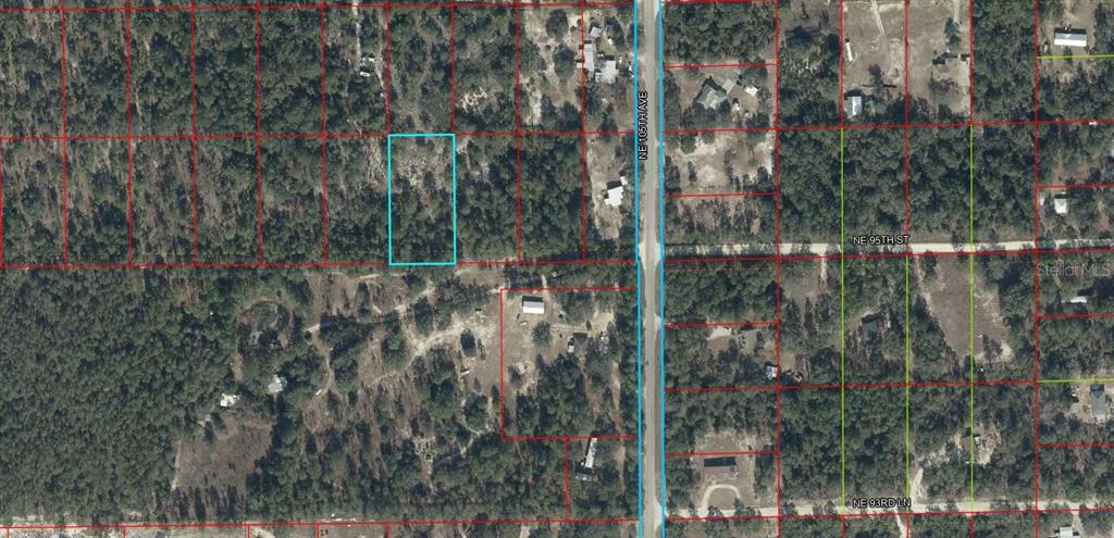 This is an aerial map showing a rectangular plot of land highlighted in light blue — 0000 NE 95TH STREET, ARCHER, FL
