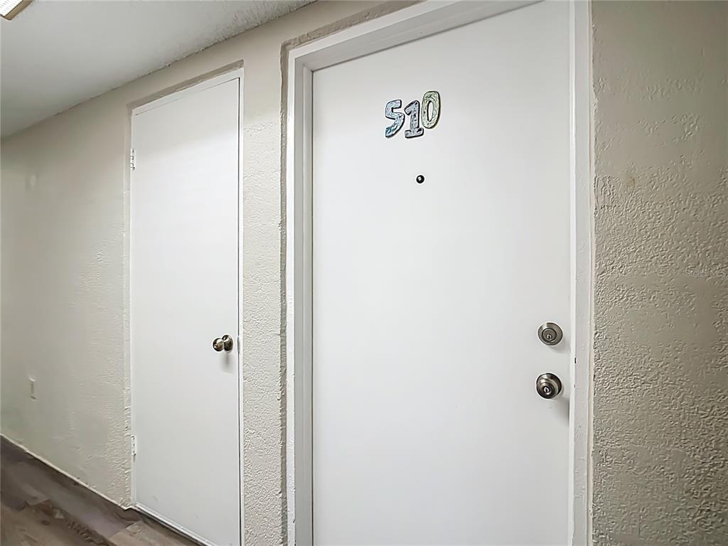 A hallway view showing two white doors, one labeled with the number 510 — 1255 TARPON CENTER DRIVE UNIT 510, VENICE, FL