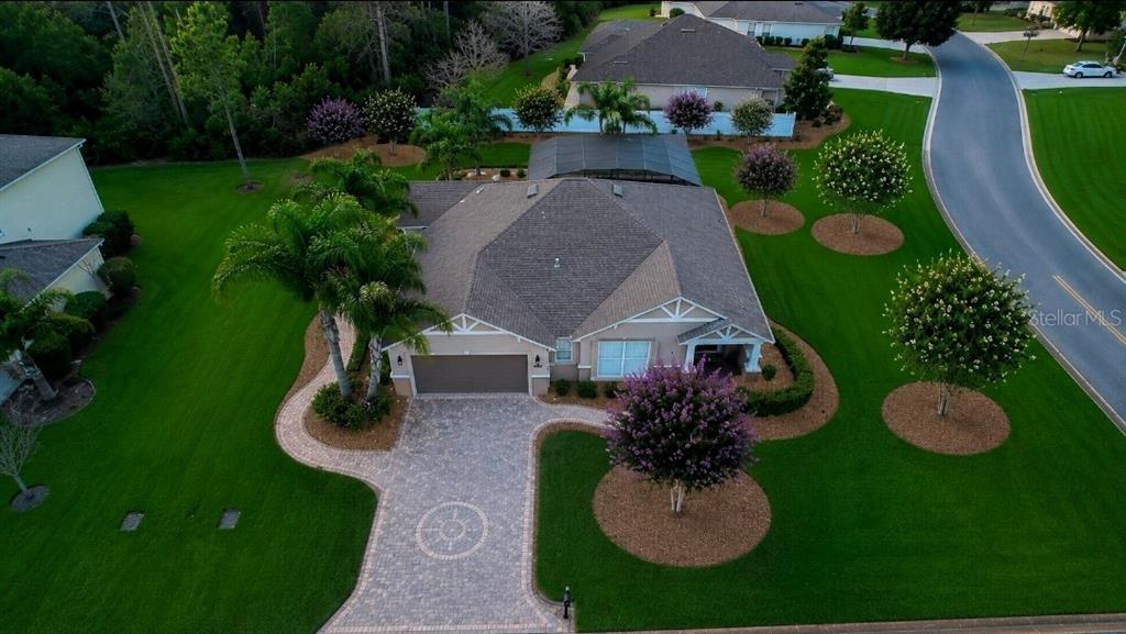 An aerial view shows a single-story house with a paved driveway and landscaped lawn — 32 ANGELA DRIVE, PALM COAST, FL