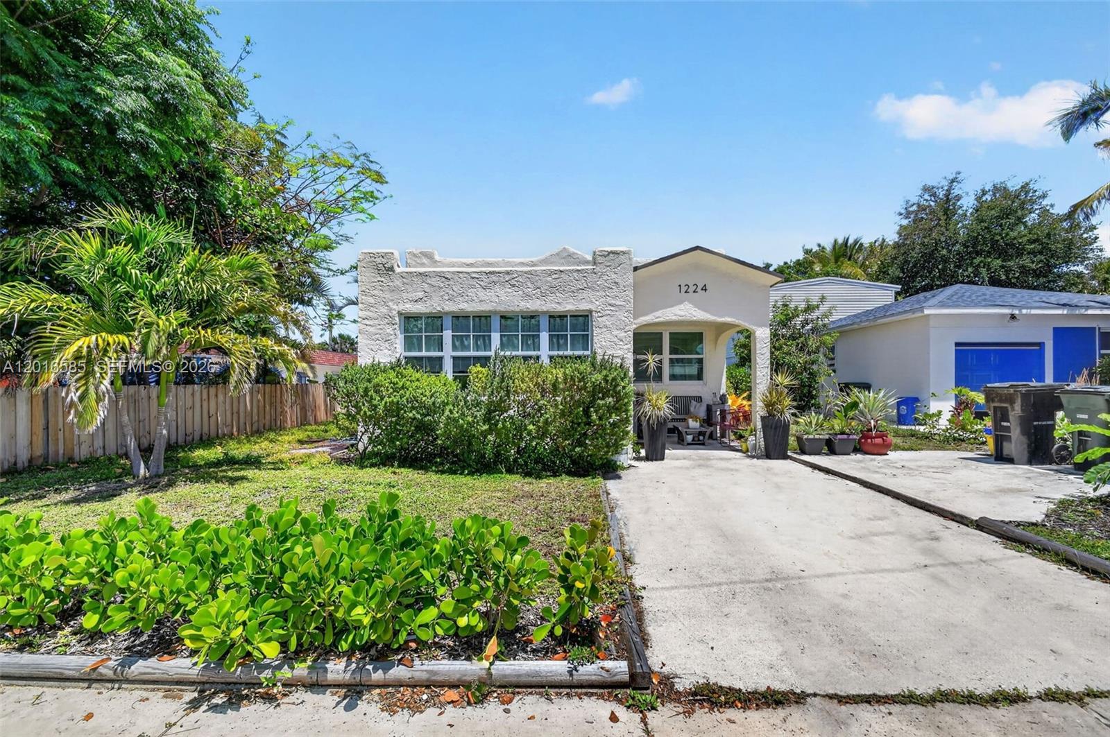 A single-story house with a stucco exterior, a front porch, and a concrete driveway — 1224 N K St, Lake Worth FL 33460, LAKE WORTH, FL
