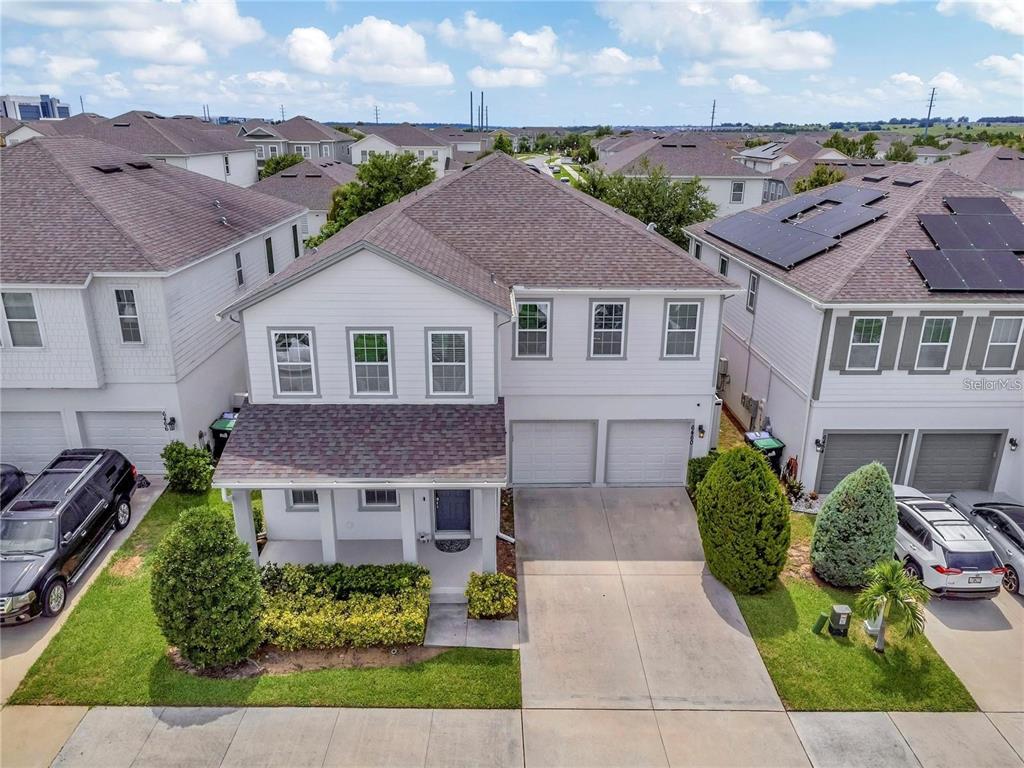 An exterior view of a two-story suburban house with a two-car garage and driveway — 6460 MAKRUT LIME DRIVE, WINTER GARDEN, FL