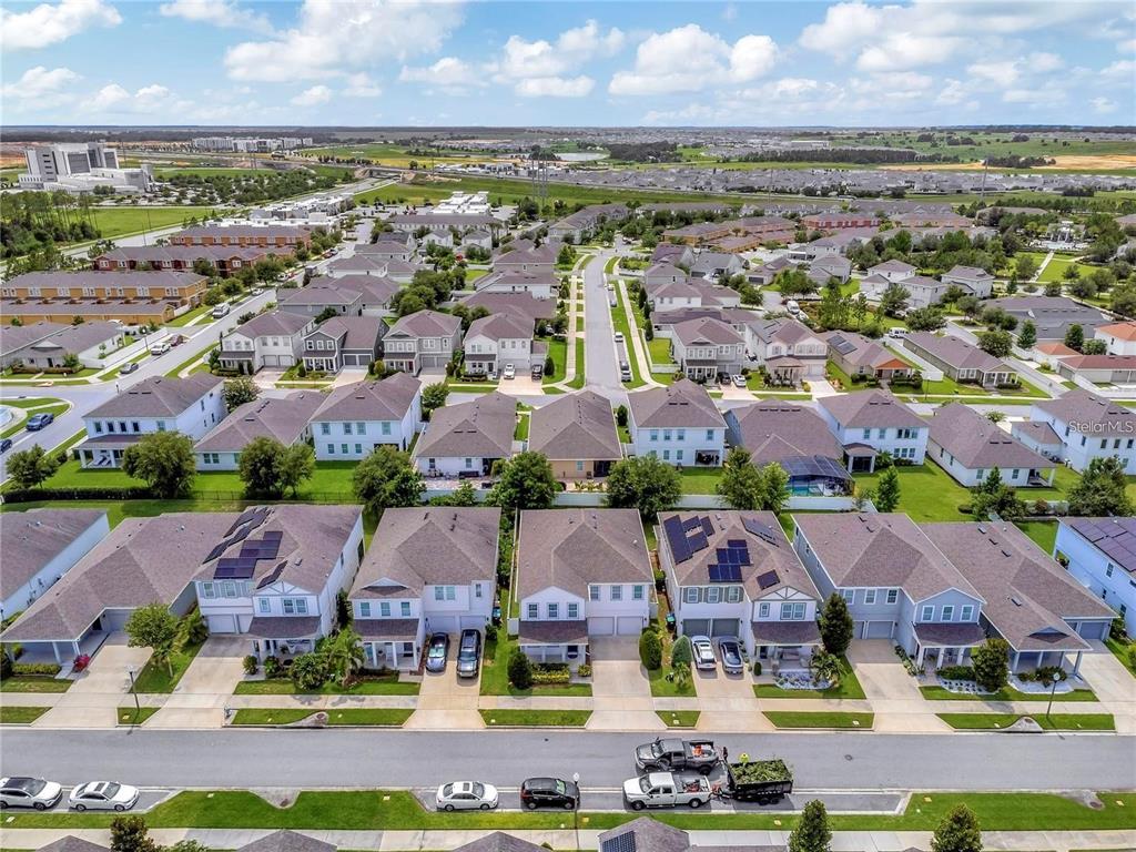 An aerial view shows a suburban neighborhood with rows of houses and parked vehicles — 6460 MAKRUT LIME DRIVE, WINTER GARDEN, FL