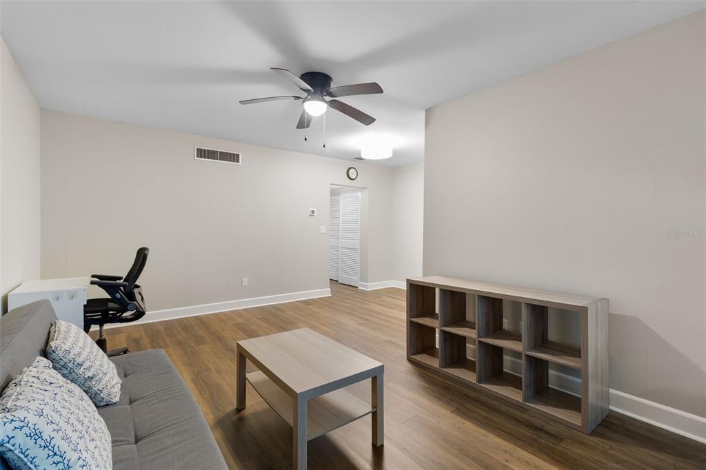 A kitchen features white cabinets, stainless steel appliances, a double sink, and a window — 1140 S ORLANDO AVENUE UNIT E11, MAITLAND, FL