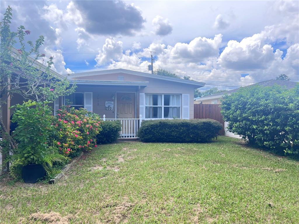 A single-story house with a tan exterior, white shutters, and a small front porch — 3612 71ST STREET N, ST PETERSBURG, FL