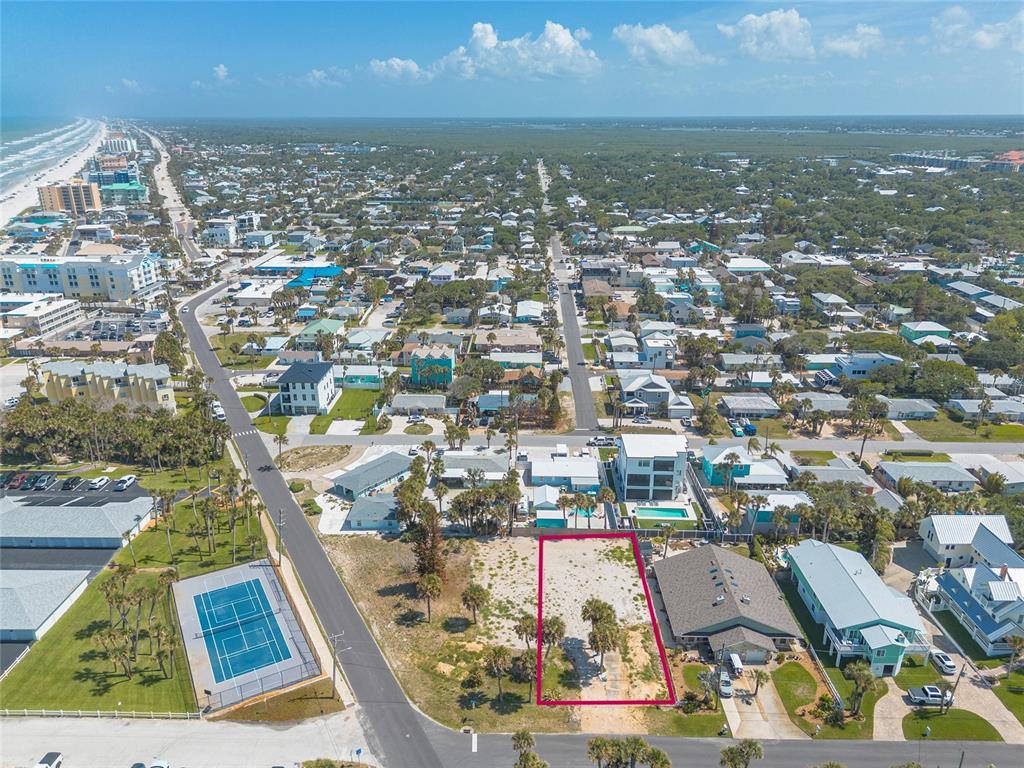 An aerial view shows a vacant rectangular lot outlined in pink near a coastal neighborhood — 0 DUE EAST STREET, NEW SMYRNA BEACH, FL