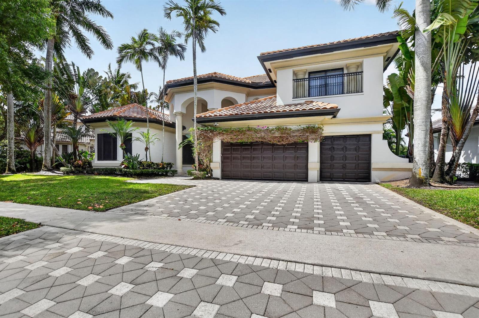 A two-story house with a tiled roof, a three-car garage, and palm trees in front — 19220 Fox Landing Drive, Boca Raton FL 33434, BOCA RATON, FL