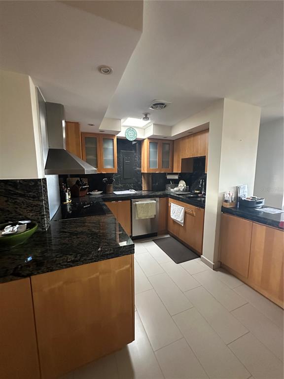 A kitchen features light wood cabinets, dark granite countertops, and stainless steel appliances — Caoba Street AVENIDA SAN PATRICIO UNIT PH1-PH2, GUAYNABO, PR