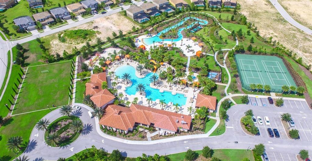 Aerial view of a community recreation center featuring a swimming pool, lazy river, and tennis courts — 1307 OAK CREST STREET, DAVENPORT, FL