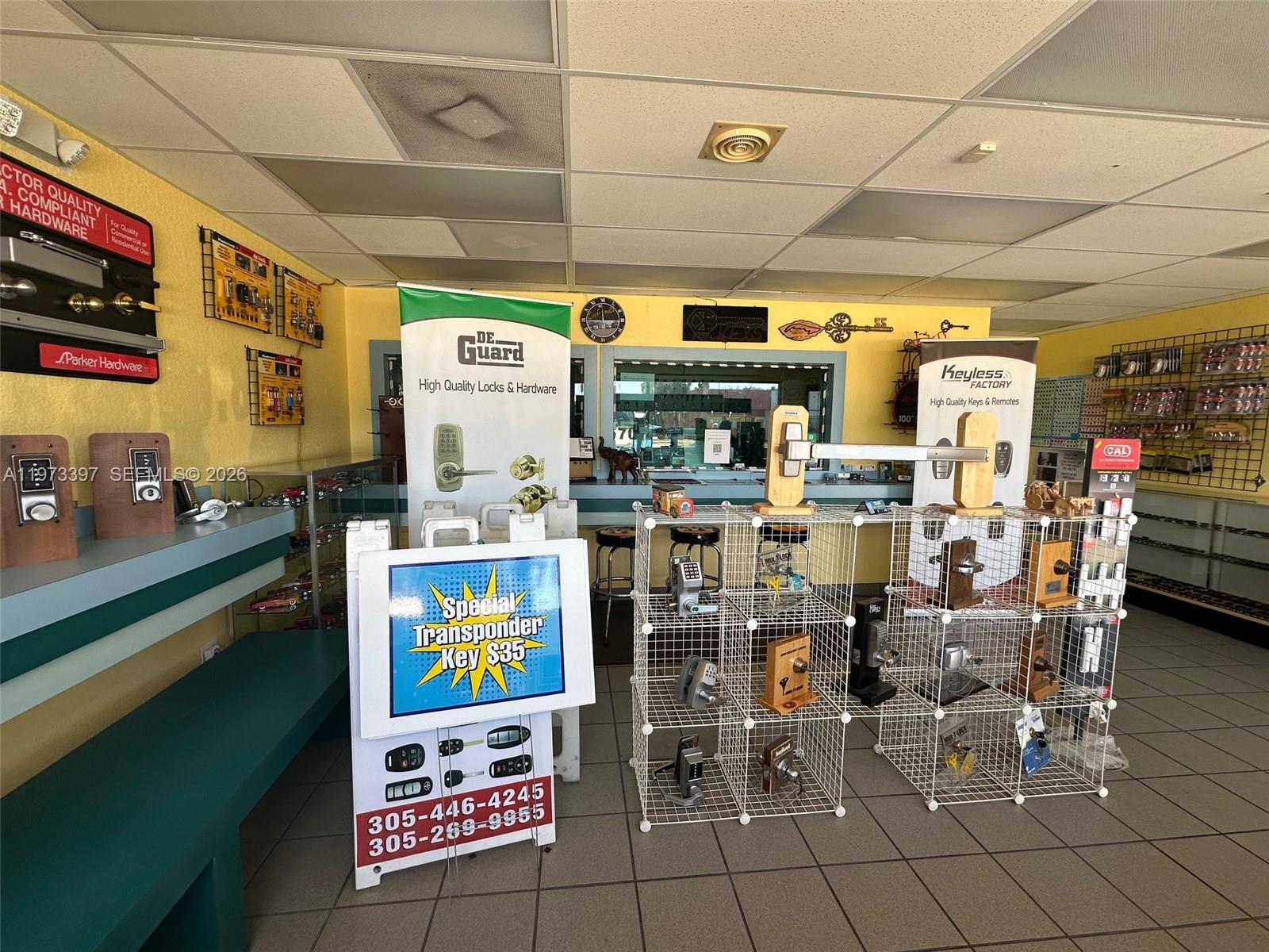 A retail locksmith shop features display racks, promotional signage, and various door hardware products — 507 E Sugarland Hwy, Clewiston FL 33440, CLEWISTON, FL