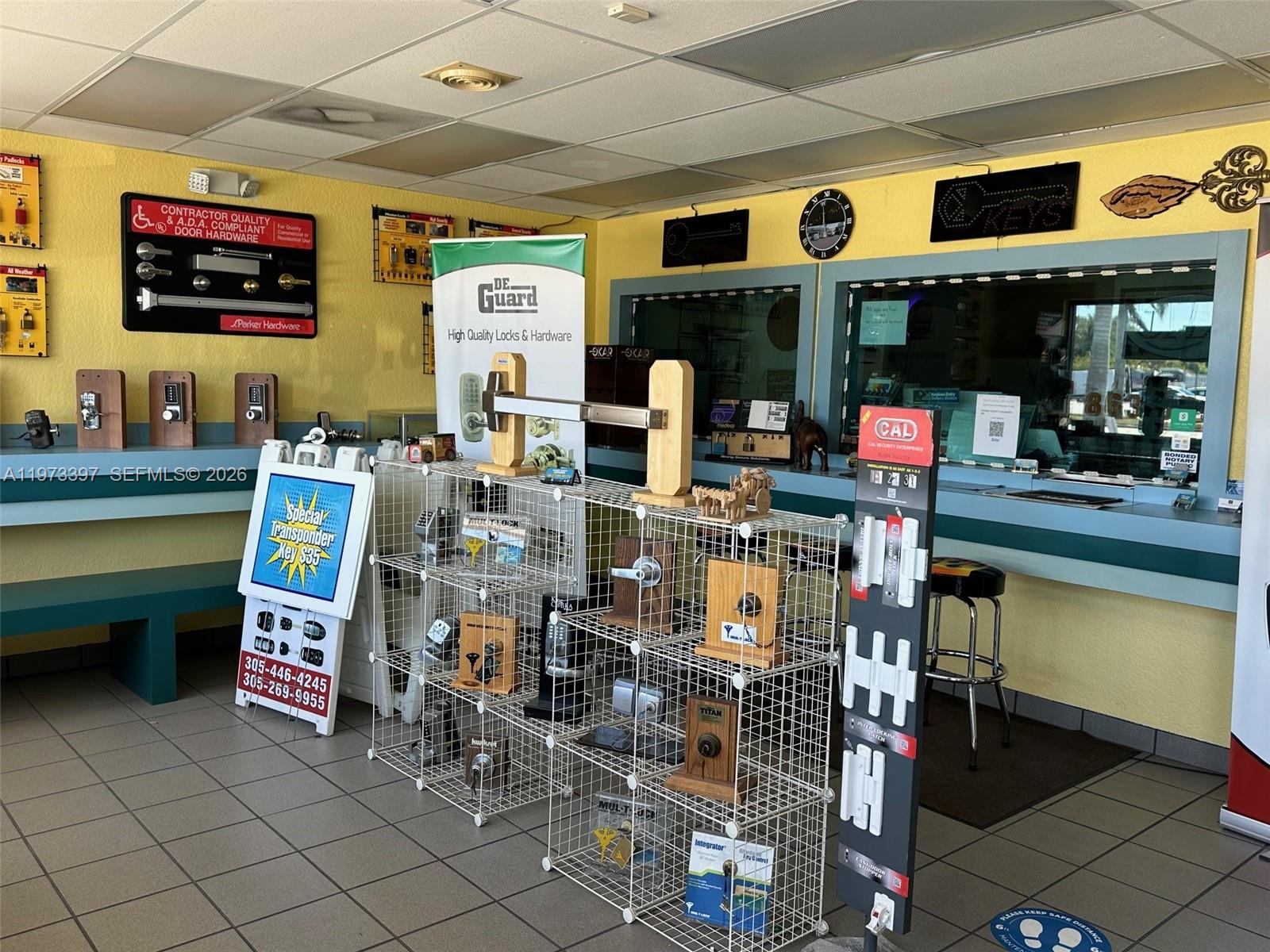 A commercial locksmith shop interior features display racks, hardware samples, and a service counter — 507 E Sugarland Hwy, Clewiston FL 33440, CLEWISTON, FL