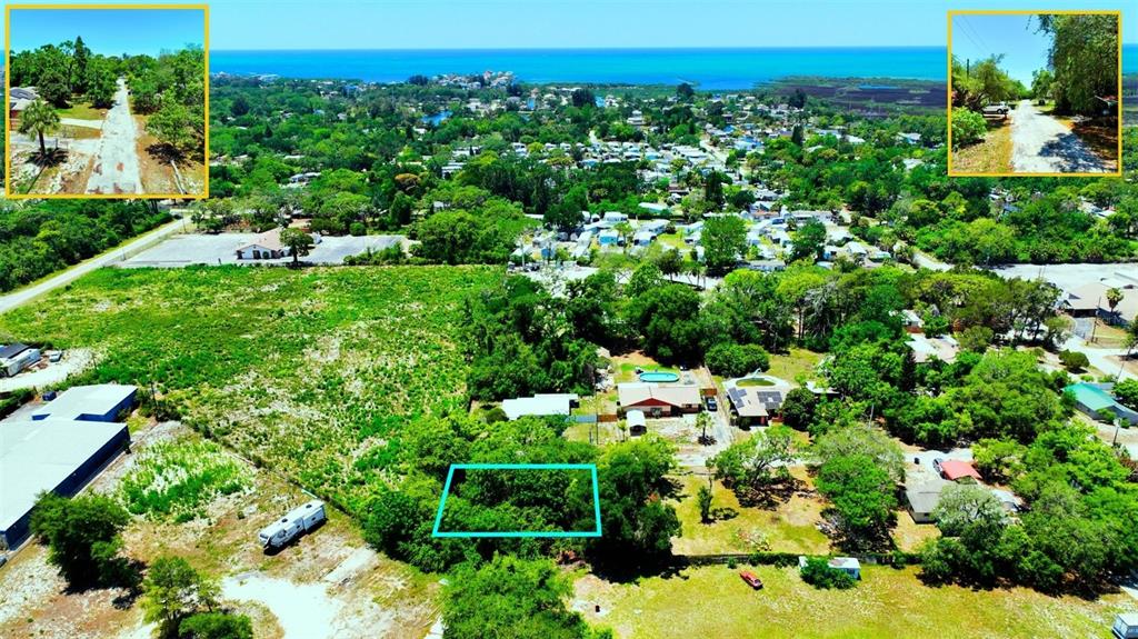 An aerial view shows a wooded lot outlined in blue amidst a residential neighborhood — TBD LOT 6 SCAMP DRIVE, HUDSON, FL