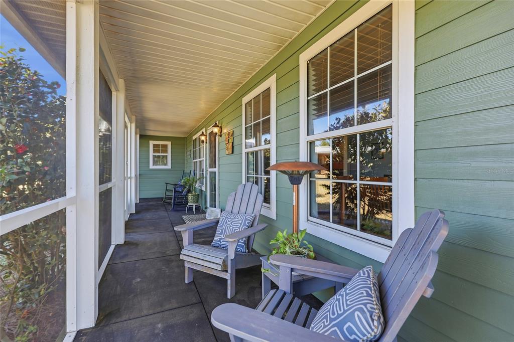 A living room features a stone fireplace, a large sectional sofa, and a ceiling fan — 27471 NW 173RD TERRACE, ALACHUA, FL