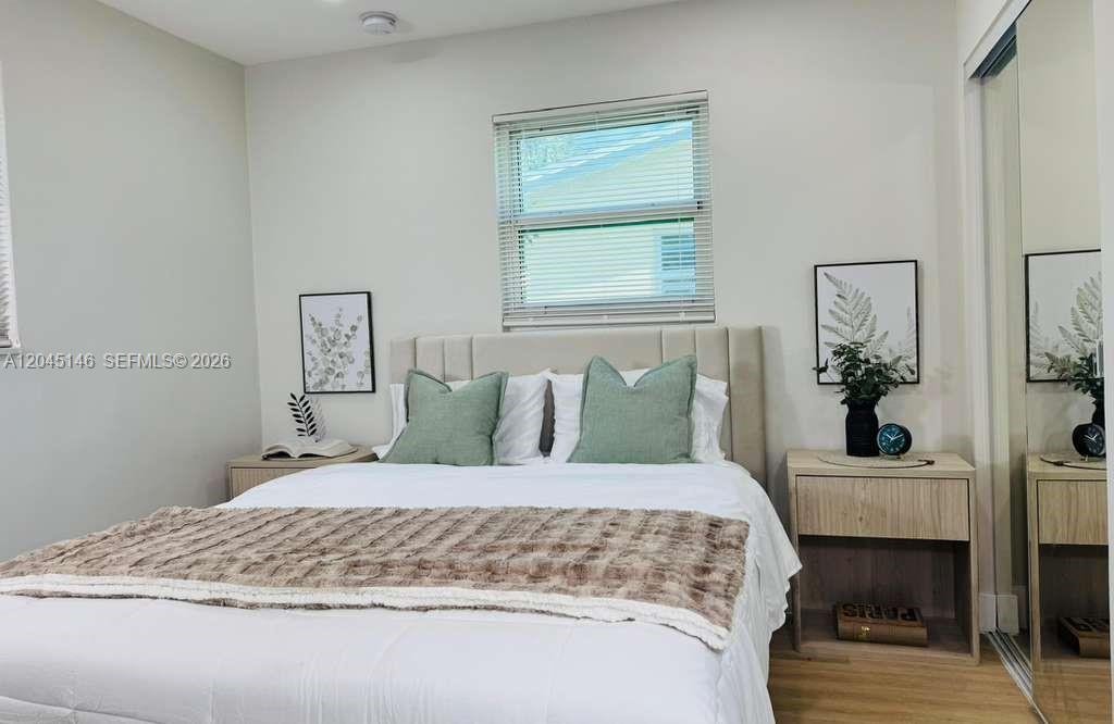 A bedroom features a bed with green pillows, two nightstands, and a window with blinds — 4708 SW 33rd Ave # 4708, Dania Beach FL 33312, DANIA BEACH, FL