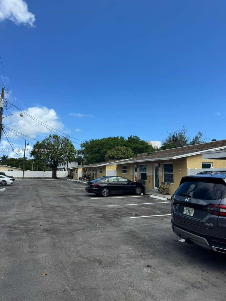 A low-rise apartment building with a parking lot in front under a clear blue sky — 4708 SW 33rd Ave # 4708, Dania Beach FL 33312, DANIA BEACH, FL