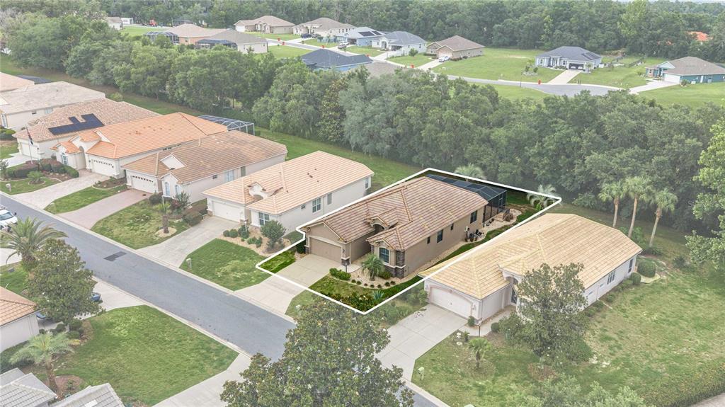 An aerial view shows a suburban house with a tiled roof and a screened-in patio — 155 W DOERR PATH, HERNANDO, FL
