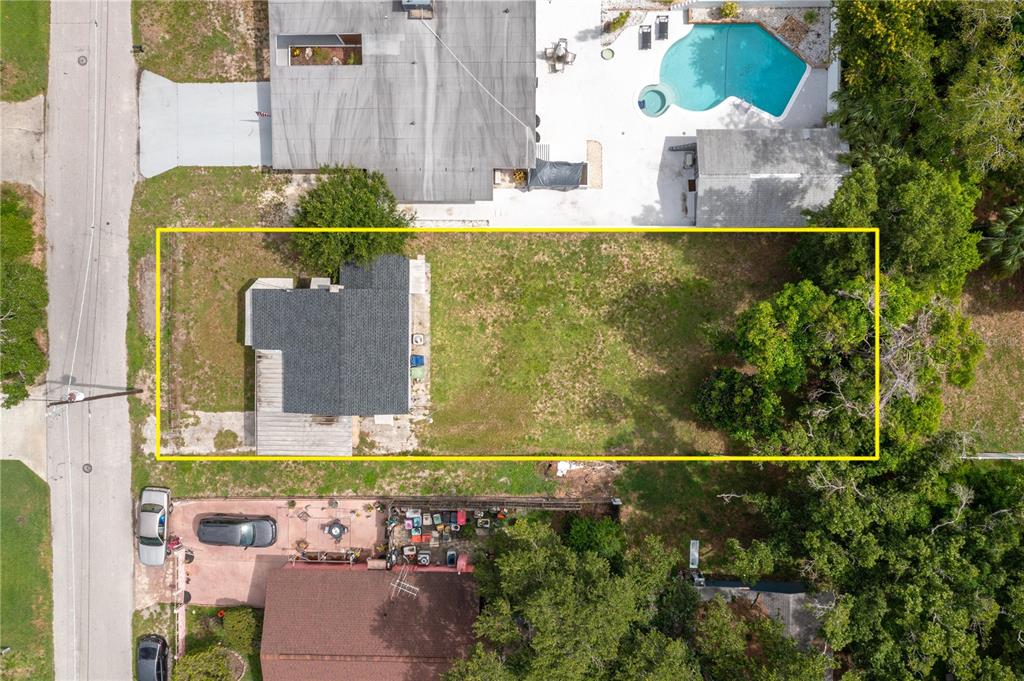 An aerial view shows a rectangular residential lot containing a house and a large yard — 3905 N CLEARFIELD AVE, TAMPA, FL