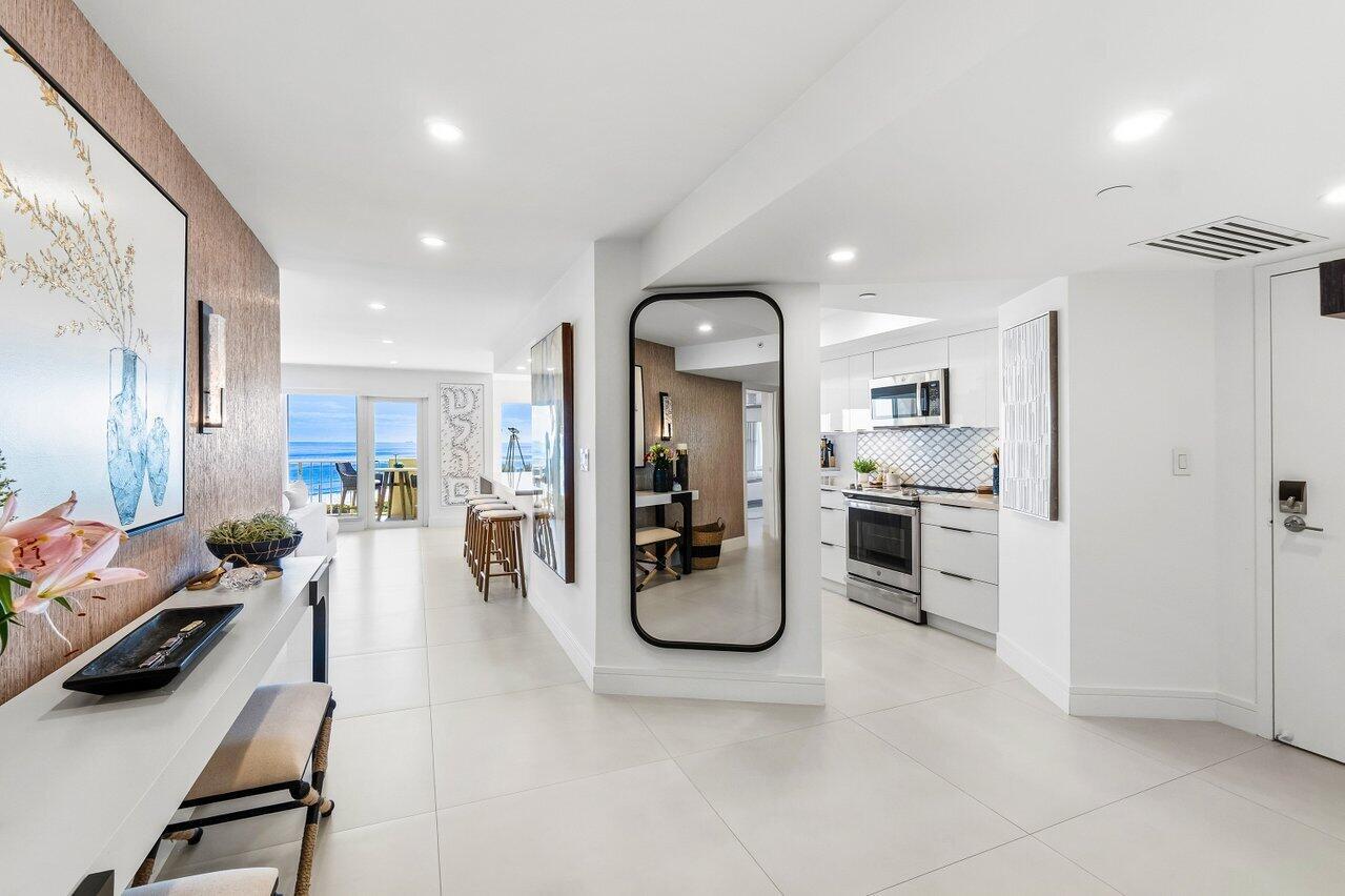 A bright, modern entryway leads to a kitchen and a living area with ocean views — 4001 N Ocean Boulevard # 907, Boca Raton FL 33431, BOCA RATON, FL
