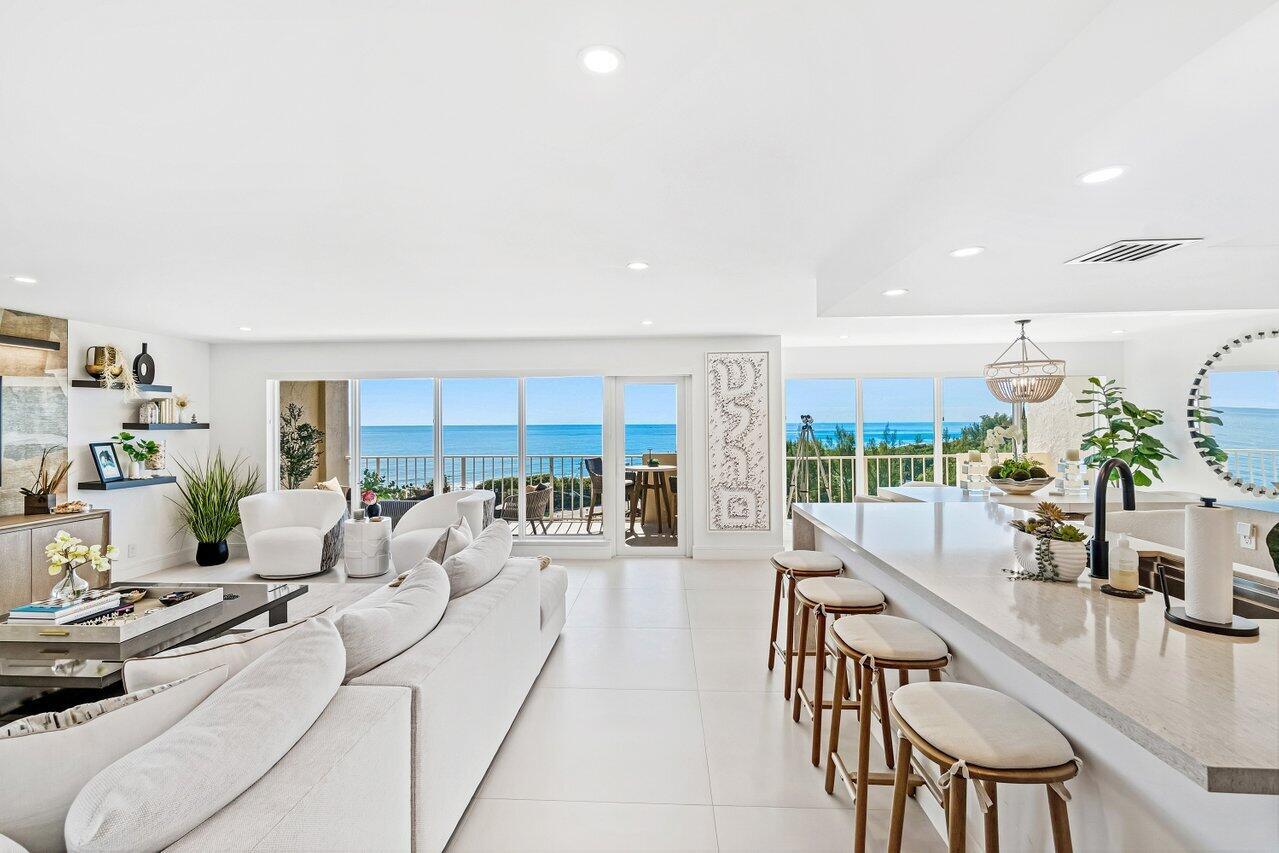 An open-concept living room and kitchen with white tile floors and ocean views — 4001 N Ocean Boulevard # 907, Boca Raton FL 33431, BOCA RATON, FL