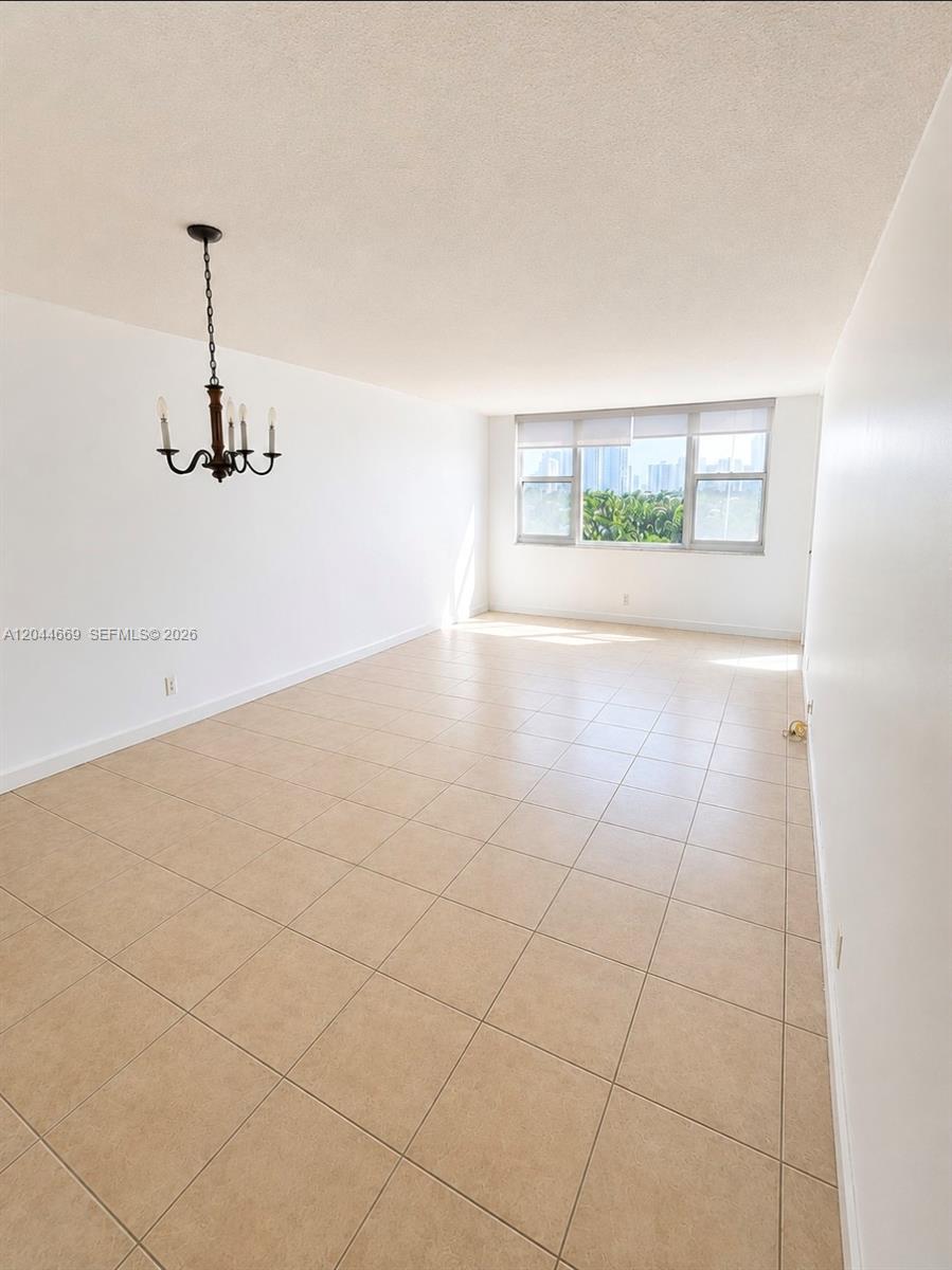 A kitchen features light wood cabinets, green countertops, white appliances, and a drop ceiling — 3180 S Ocean Dr # 621, Hallandale Beach FL 33009, HALLANDALE BEACH, FL