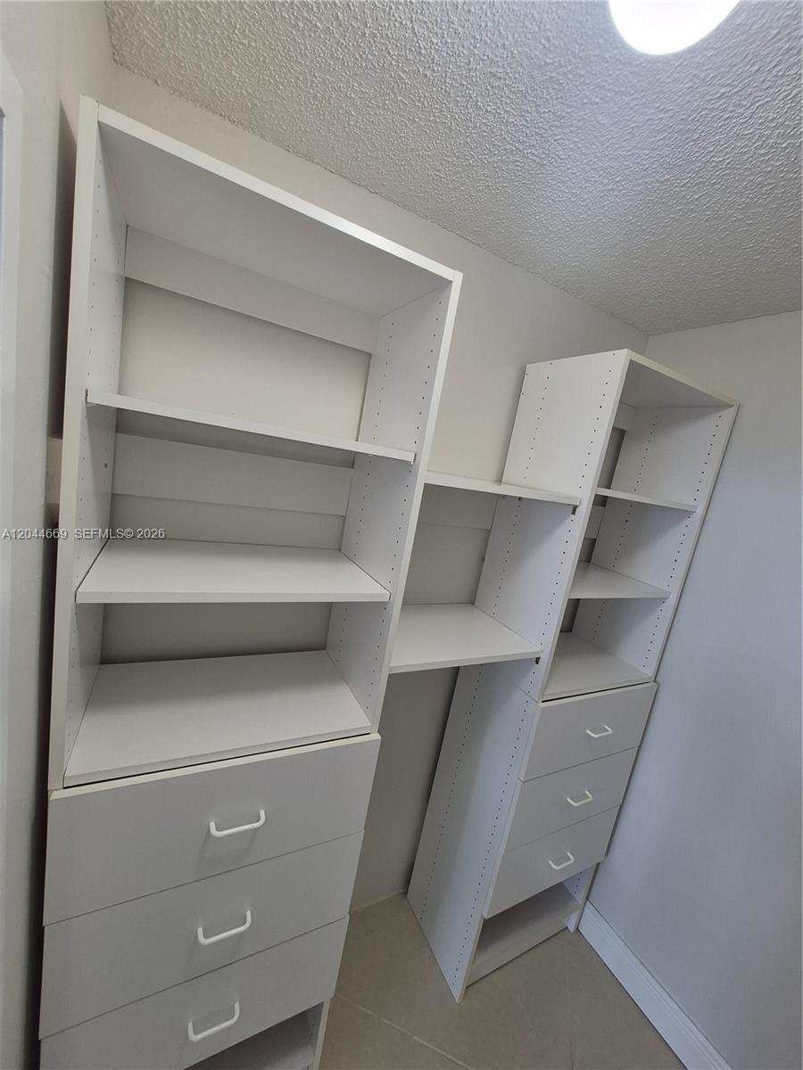 An empty room features white walls, a large window, and beige tile flooring — 3180 S Ocean Dr # 621, Hallandale Beach FL 33009, HALLANDALE BEACH, FL