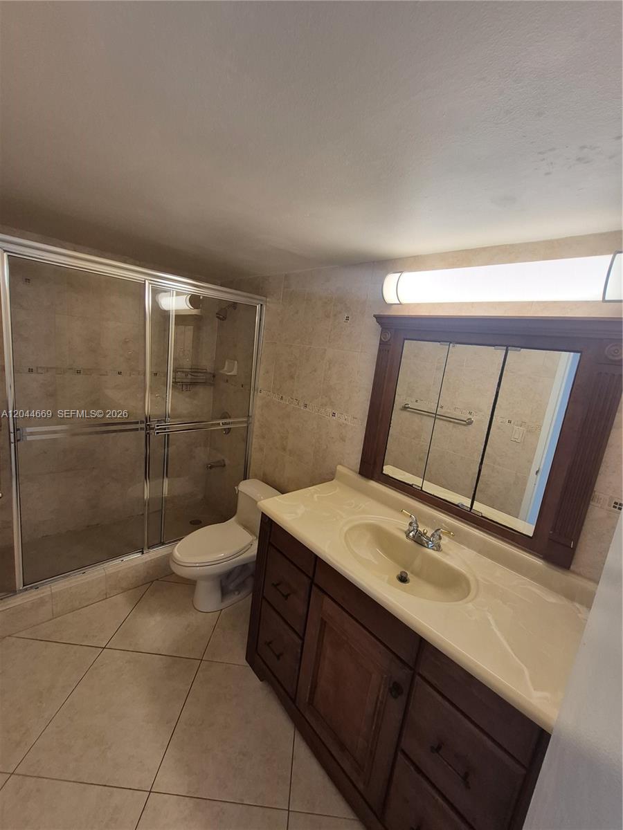 A walk-in closet features white modular shelving units with built-in drawers and open storage — 3180 S Ocean Dr # 621, Hallandale Beach FL 33009, HALLANDALE BEACH, FL