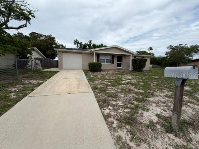 A single-story house with a concrete driveway, a garage, and a mailbox in the yard — 7539 GULF HIGHLANDS DRIVE, PORT RICHEY, FL