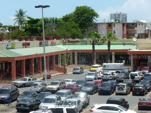 A multi-tenant commercial shopping center features a parking lot filled with various vehicles — 0 BALDORIOTY DE CASTRO AVE. INT. ARCOIRIS, SAN JUAN, PR