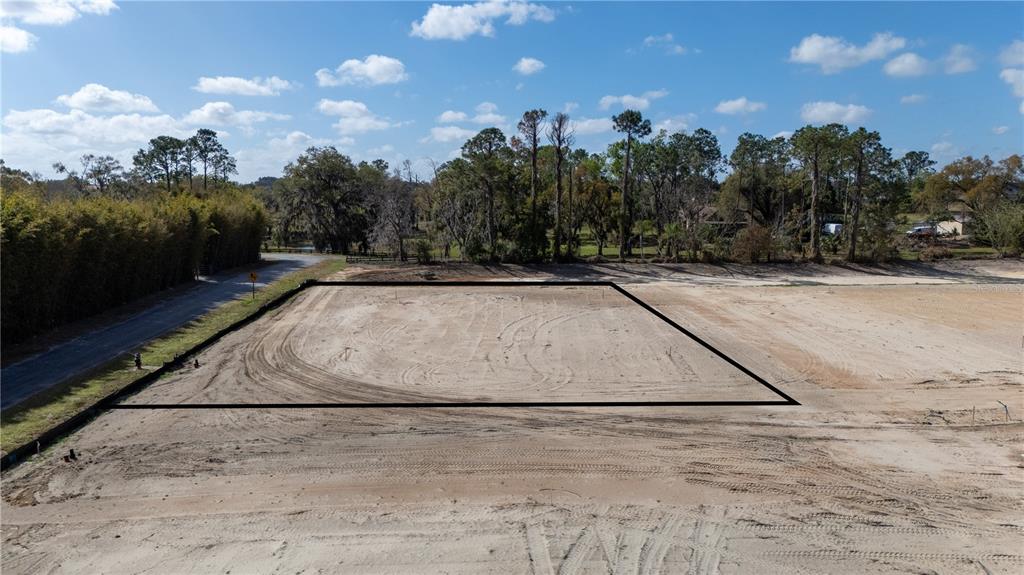 An aerial view shows a cleared, rectangular plot of land outlined in black — 12883 POMPANIC STREET, SAN ANTONIO, FL