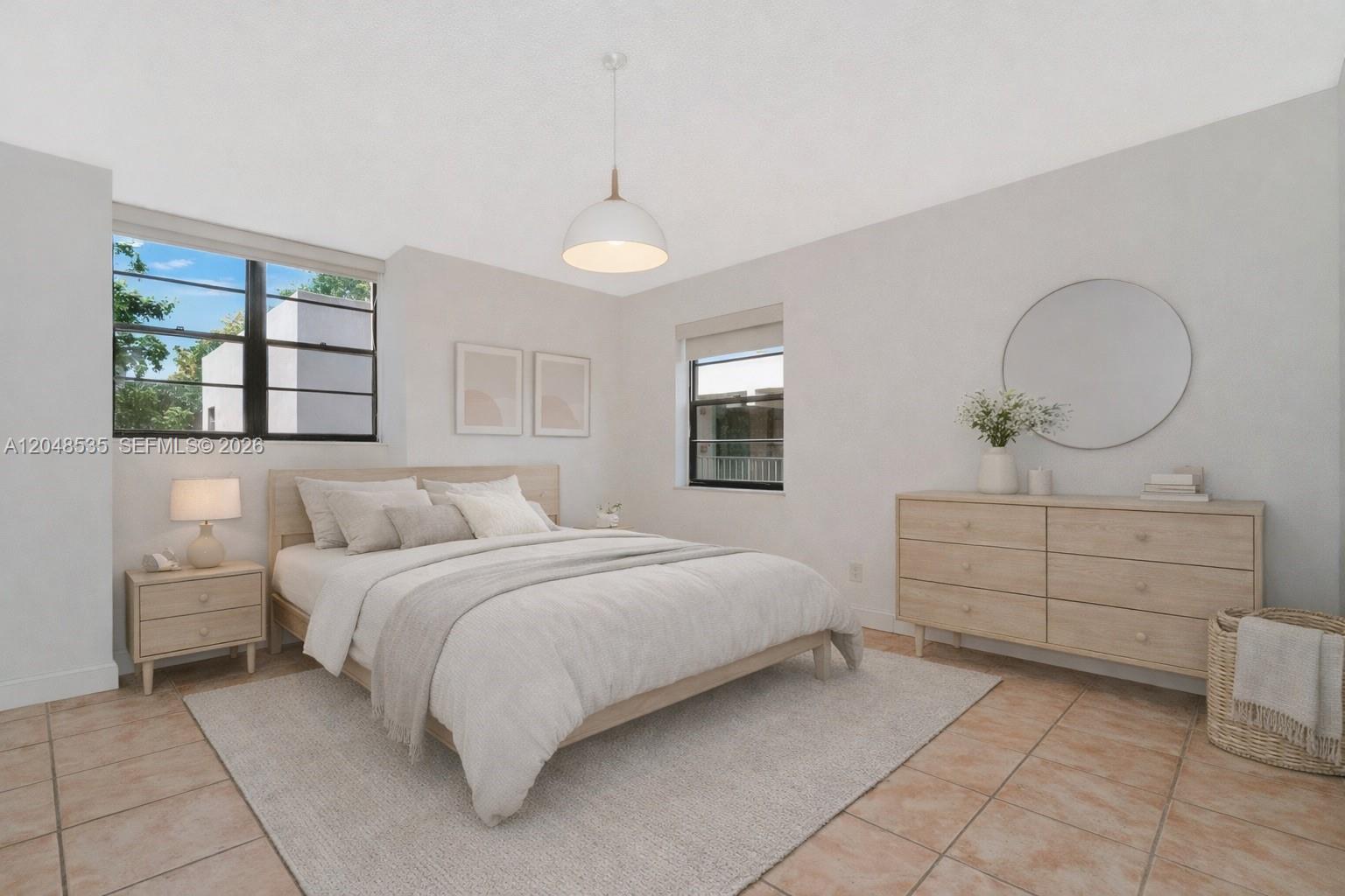 A bedroom features a bed, dresser, rug, and tile flooring under a pendant light — 10525 SW 112th Ave # 309, Miami FL 33176, MIAMI, FL