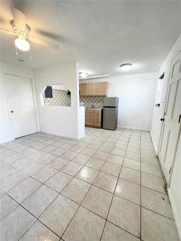 A kitchen with light wood cabinets, stainless steel appliances, and beige tile flooring — 2916 NORTH 16TH STREET UNIT 2, TAMPA, FL