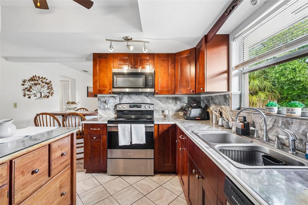 This is a floor plan for a single-story house featuring four bedrooms and a garage — 3777 PARKWAY BOULEVARD, LAND O LAKES, FL