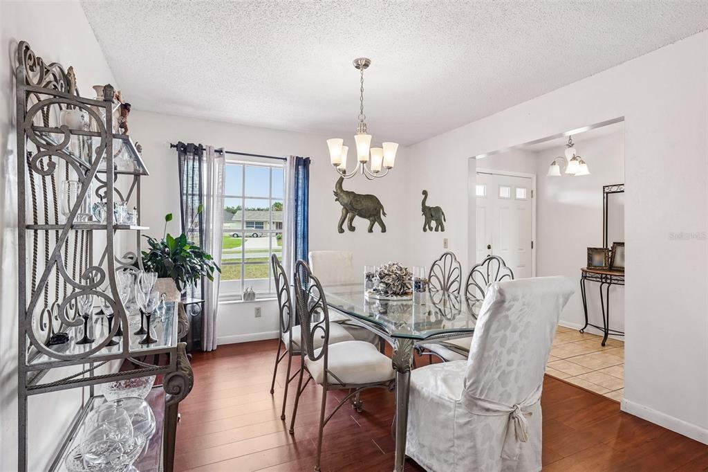 A living room with wood flooring, gray sofas, a coffee table, and a breakfast bar — 3777 PARKWAY BOULEVARD, LAND O LAKES, FL