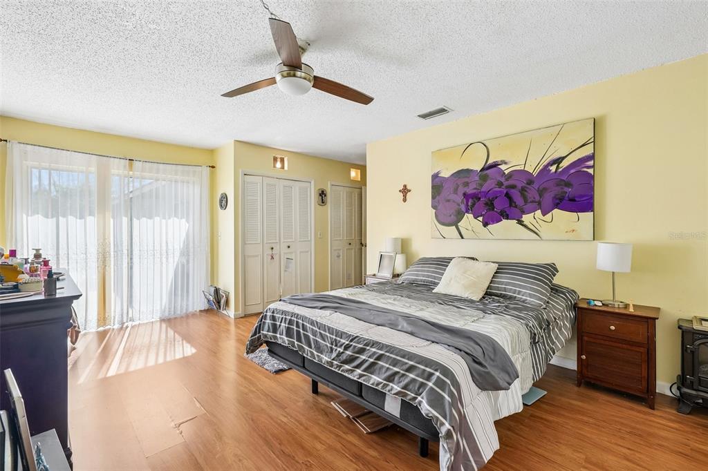 A kitchen features wood cabinets, stainless steel appliances, and a gray marble-patterned backsplash — 3777 PARKWAY BOULEVARD, LAND O LAKES, FL