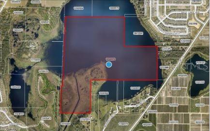 This aerial map shows a large, irregularly shaped parcel of land highlighted in red — SR-19, GROVELAND, FL