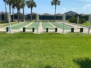 An outdoor shuffleboard court with benches and palm trees under a clear blue sky — 30 SAN RAFAEL COURT, PALM COAST, FL