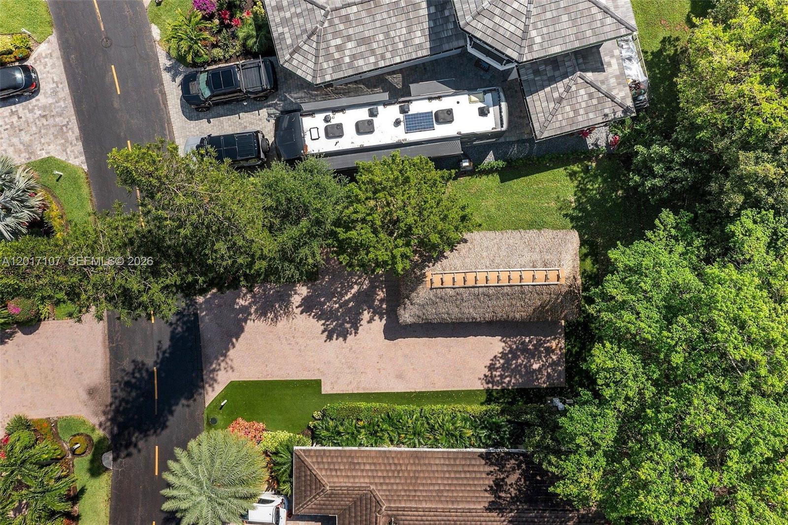 An aerial view shows a residential property with a driveway, a large RV, and a tiki hut — 22 S Cortez Dr, Margate FL 33068, MARGATE, FL