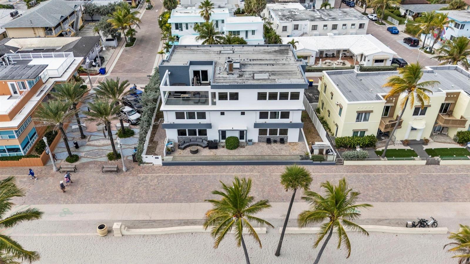 An aerial view shows a multi-story white building with a flat roof and balconies — 2203 N Surf Road, Hollywood FL 33019, HOLLYWOOD, FL