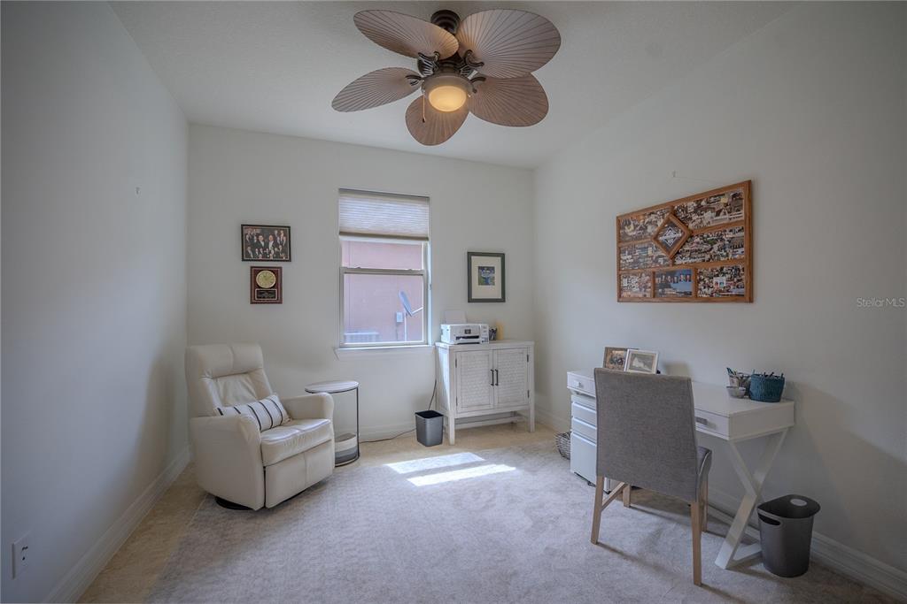 A home office features a desk, a recliner, a ceiling fan, and a window — 9576 SW 65TH PLACE, OCALA, FL