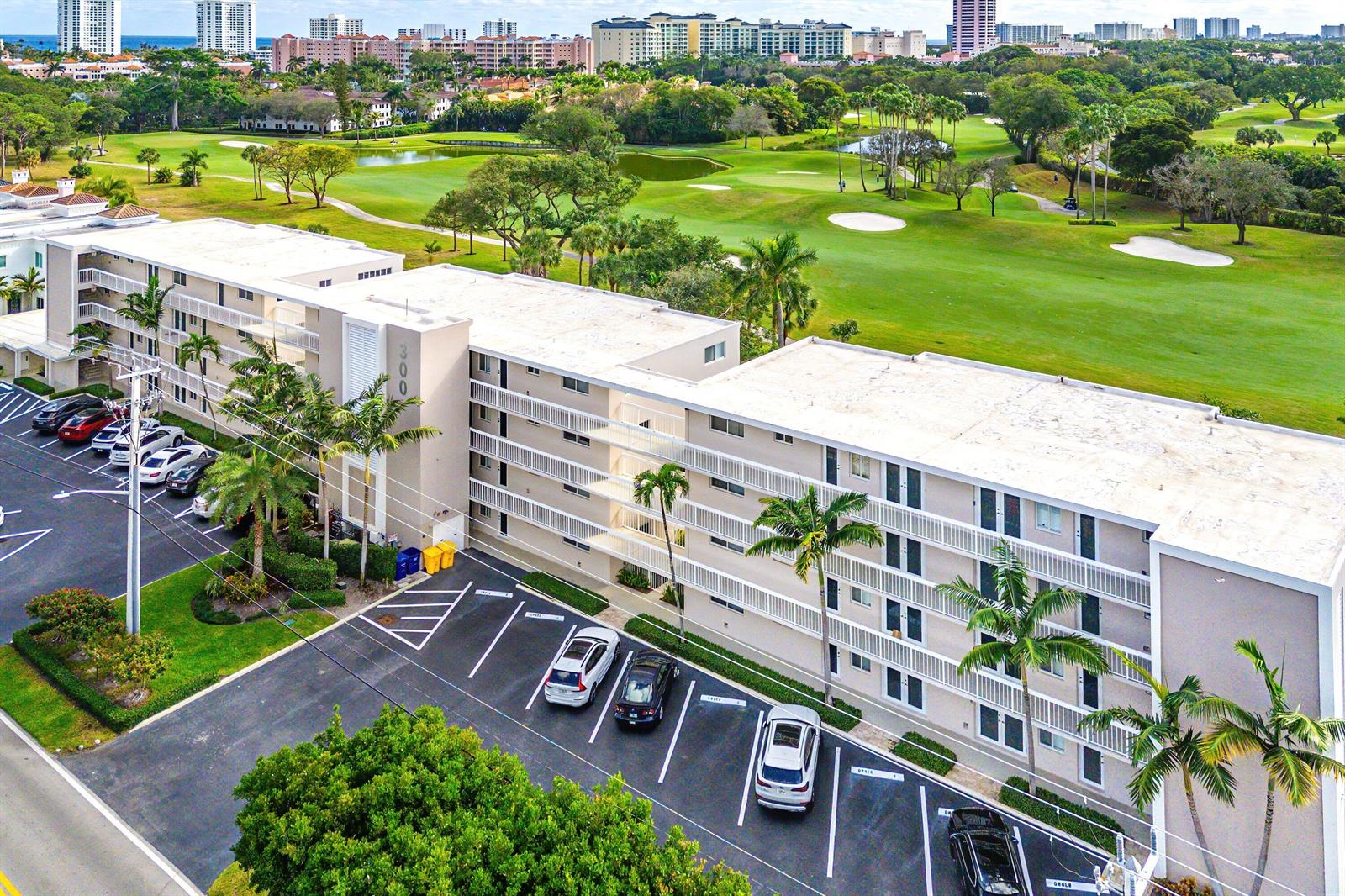 An aerial view shows a multi-story apartment building adjacent to a golf course — 300 E Royal Palm Road # 0350, Boca Raton FL 33432, BOCA RATON, FL