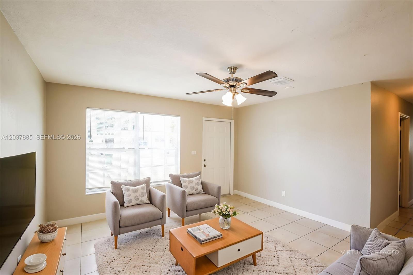 A living room features light-colored tile floors, a ceiling fan, and virtual staging furniture — 5980 NW 24th Ct, Margate FL 33063, MARGATE, FL
