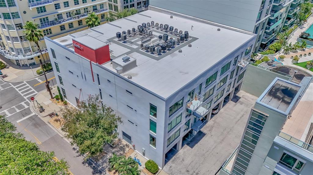 An aerial view shows a multi-story building with a flat roof featuring numerous HVAC units — 101 N 12TH STREET UNIT 302, TAMPA, FL