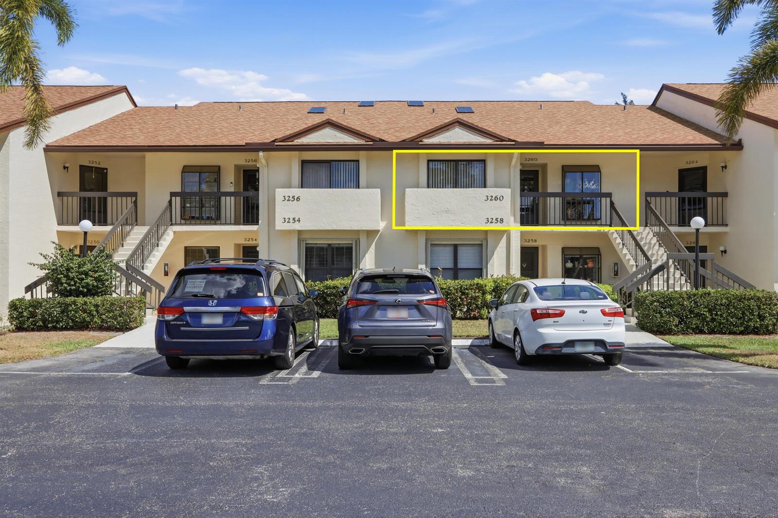 An exterior view of a two-story apartment building with a highlighted second-floor balcony — 3260 Perimeter Drive, FL 33467, FL