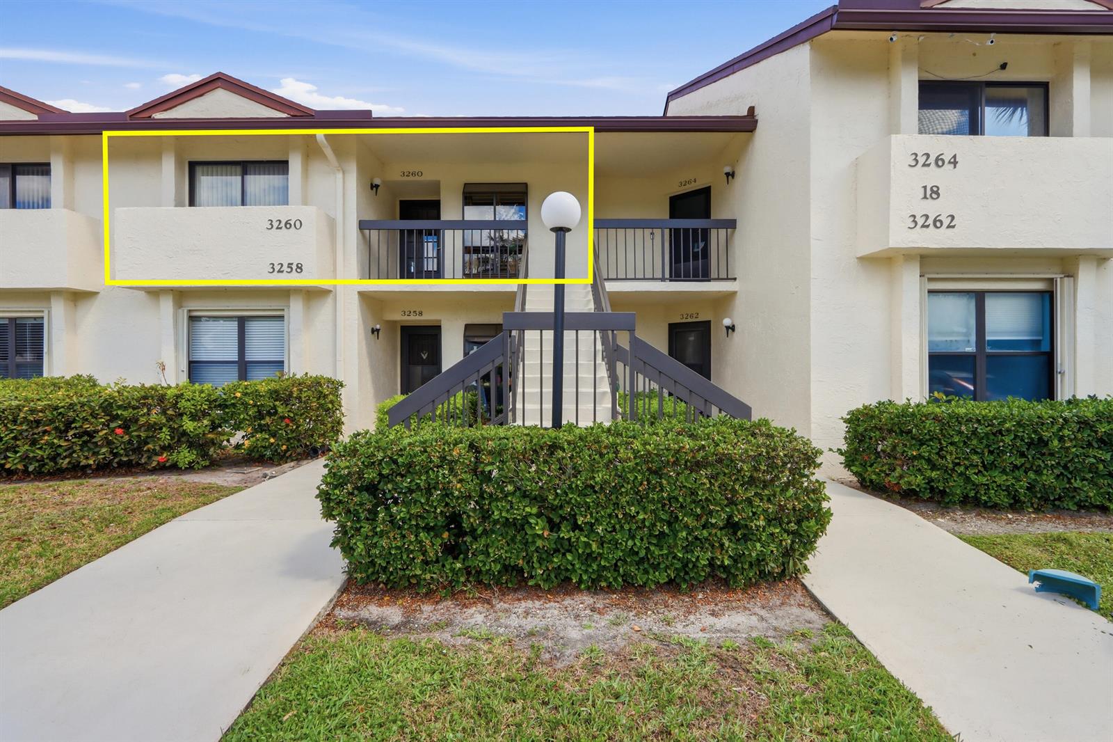 An exterior view of a two-story apartment building with a highlighted second-floor balcony — 3260 Perimeter Drive, FL 33467, FL