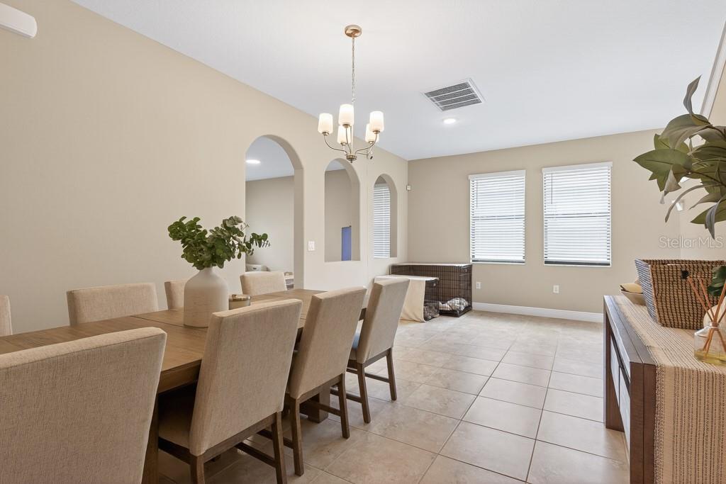 A bathroom features a glass-enclosed shower, a corner soaking tub, and dual dark wood vanities — 12636 SOURWOOD WAY, NEW PORT RICHEY, FL