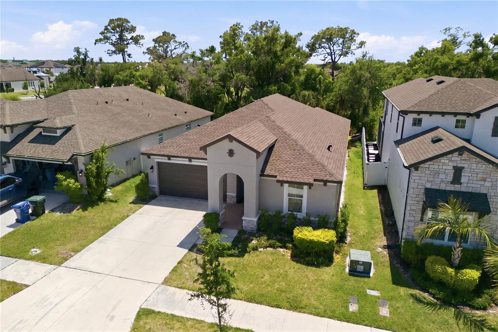 An aerial view of a single-story suburban house with a brown roof and concrete driveway — 3557 SECLUDED COURT, SARASOTA, FL