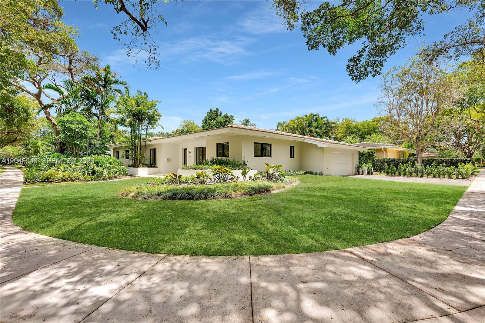 A single-story house with a white exterior, a garage, and a landscaped front lawn — 950 Bayamo Ave, Coral Gables FL 33146, CORAL GABLES, FL
