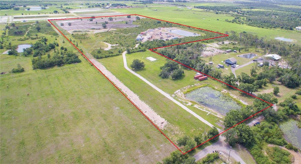 An aerial view shows a large, rural property outlined in red with ponds and structures — 7977 BARR ROAD, MYAKKA CITY, FL